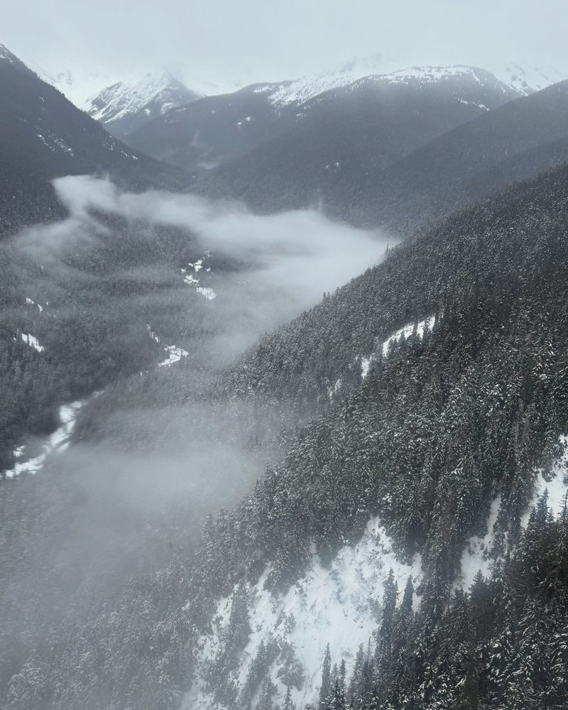 Mist in a snowy valley below the gondola at Whistler, British Columbia